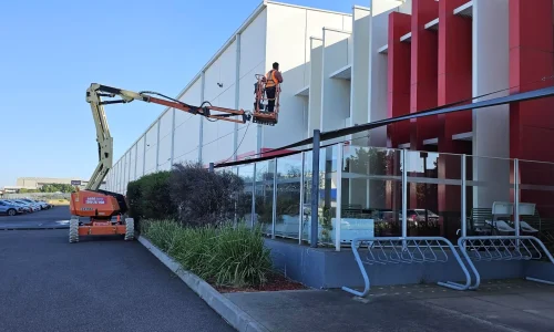 Technician pressure washing a concrete driveway
