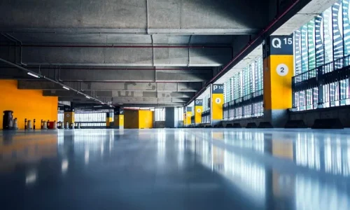 empty-garage-with-parking-lots-with-concrete-ceiling-flooring-pillars-marked-with-numbers_342744-1241